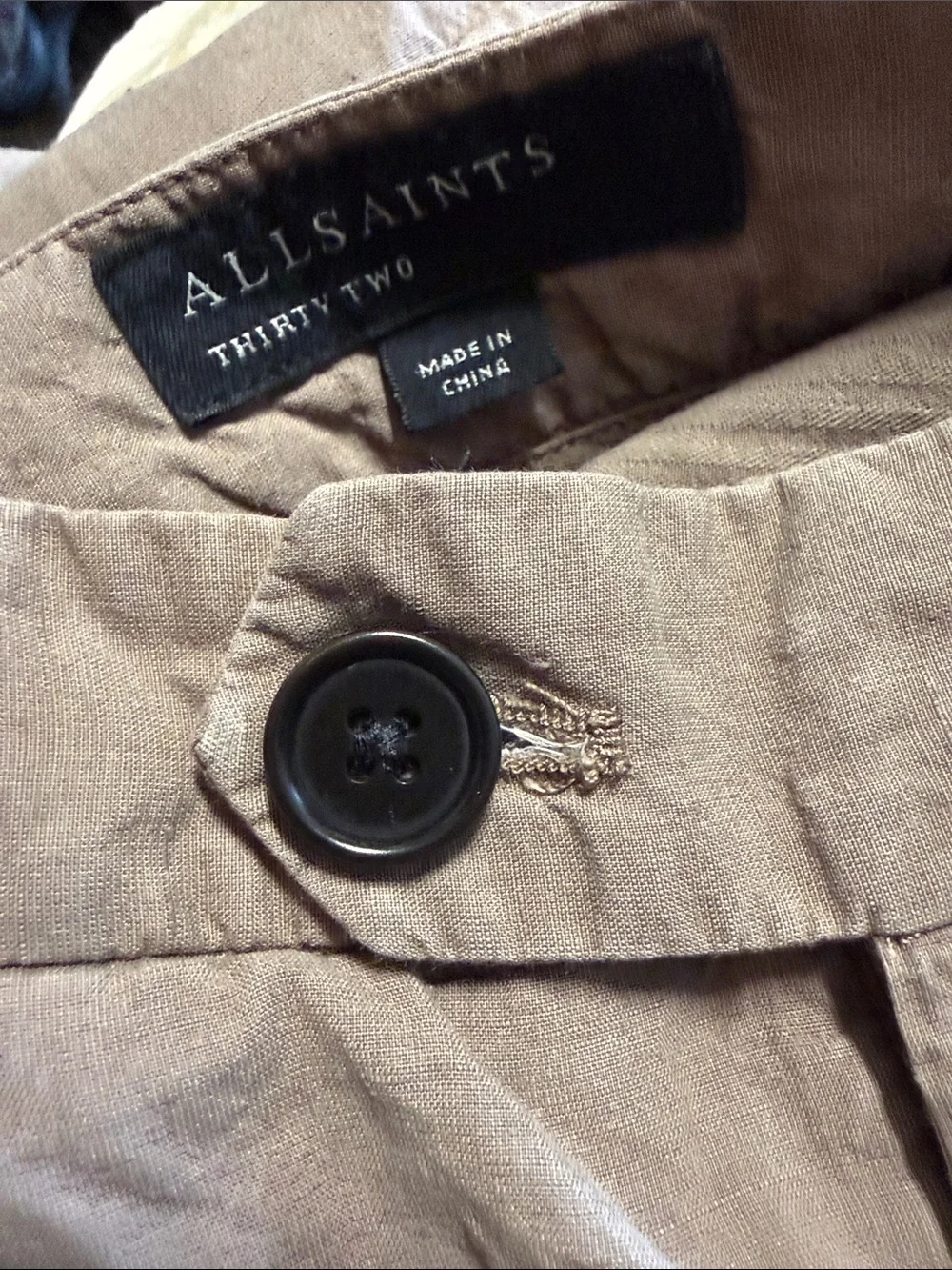 AllSaints trousers with a pleated front and a button closure